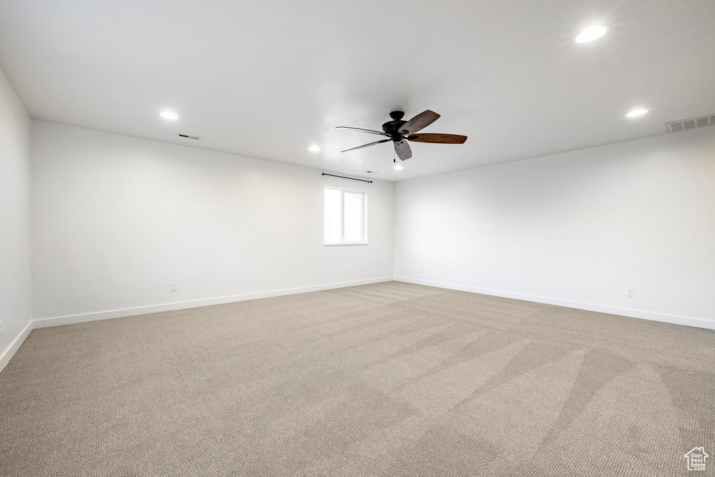 Carpeted spare room with recessed lighting, ceiling fan, and baseboards