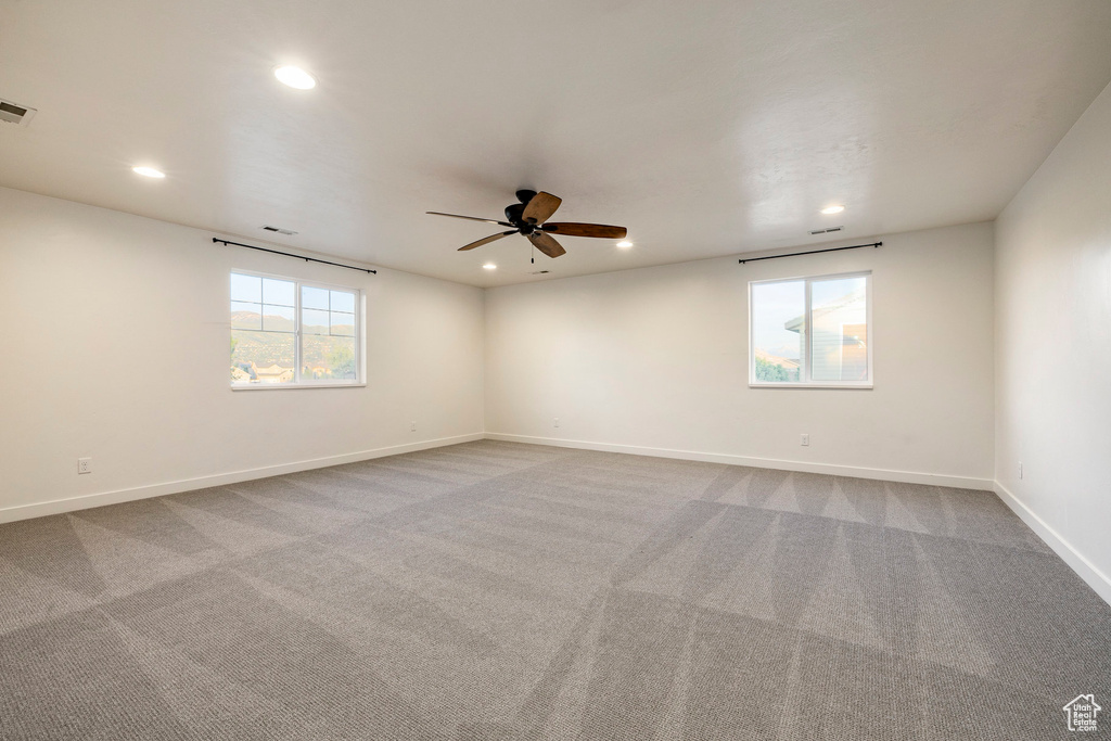 Spare room featuring a ceiling fan, recessed lighting, carpet floors, and baseboards