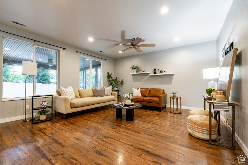 Living room featuring hardwood / wood-style floors, baseboards, and recessed lighting