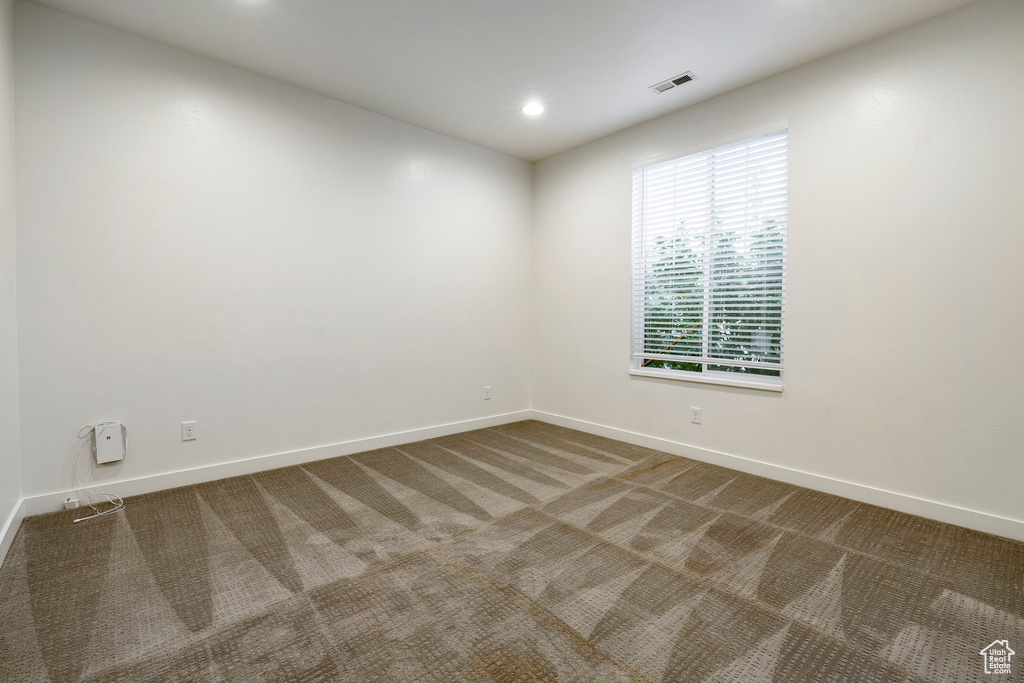 Empty room featuring baseboards, carpet, and recessed lighting