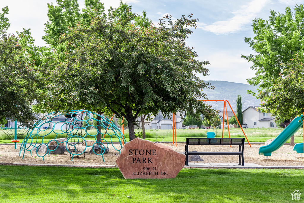 Community playground featuring a lawn and a mountain view