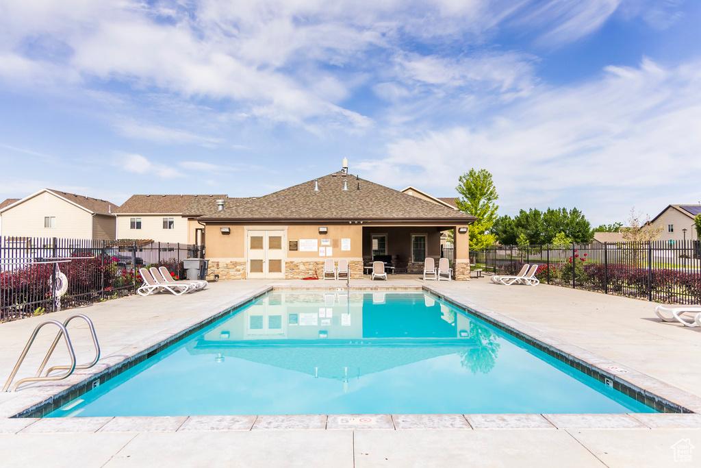 Community pool featuring a patio