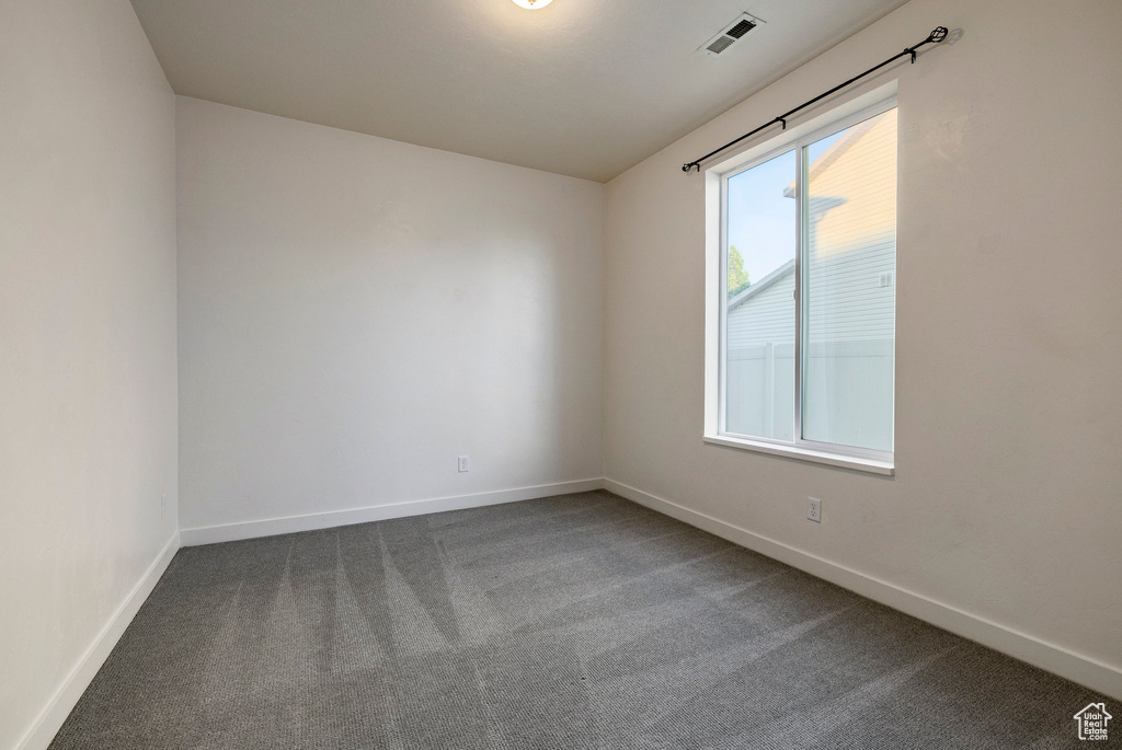 Spare room with carpet and baseboards