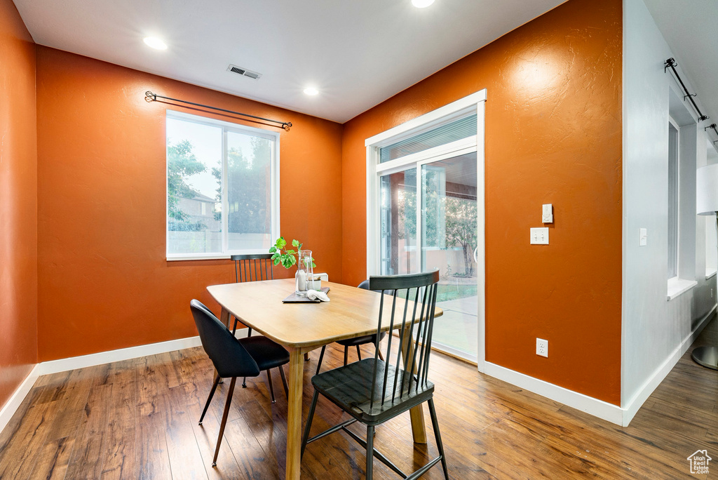 Dining area featuring wood finished floors, healthy amount of natural light, baseboards, and recessed lighting