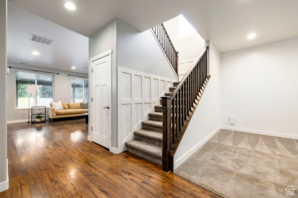 Stairs featuring recessed lighting, baseboards, and hardwood / wood-style floors