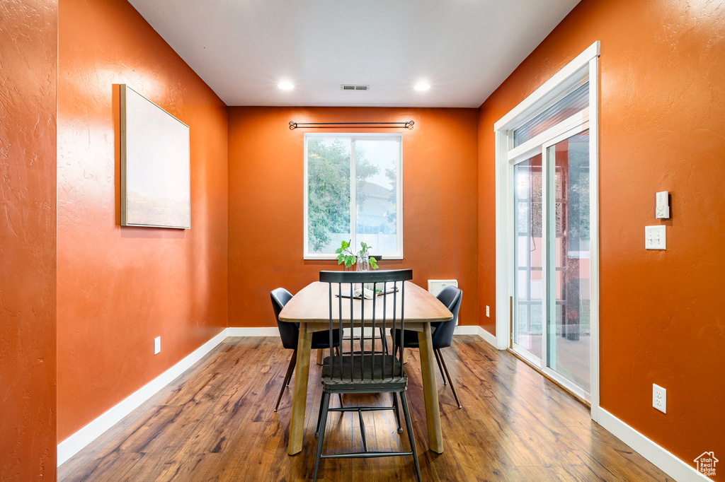 Dining space with hardwood / wood-style flooring, baseboards, and recessed lighting