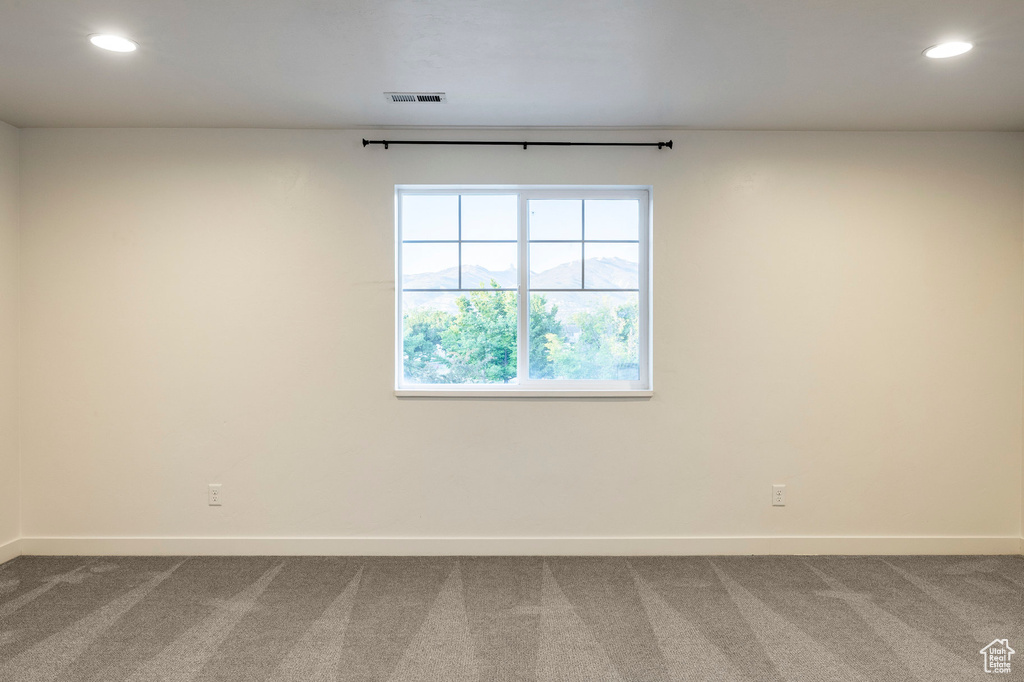 Spare room featuring carpet, baseboards, and recessed lighting