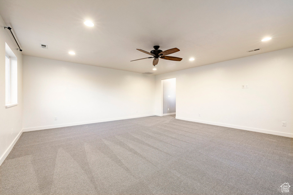 Empty room featuring recessed lighting, ceiling fan, carpet floors, and baseboards