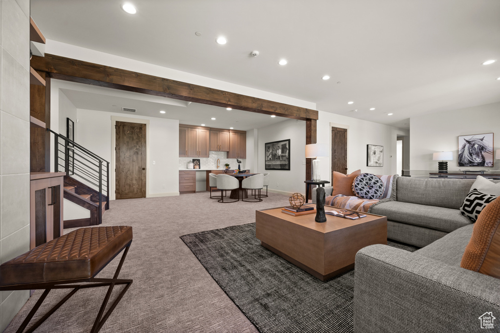 Living room with recessed lighting, light carpet, stairway, and baseboards