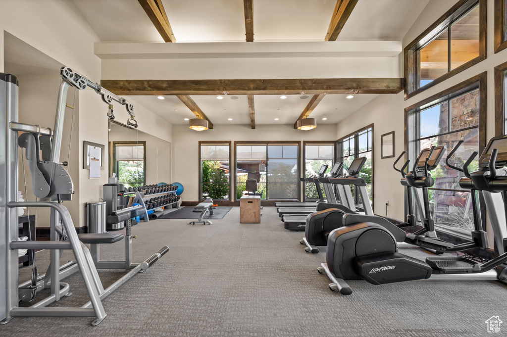 Workout area with beam ceiling and recessed lighting