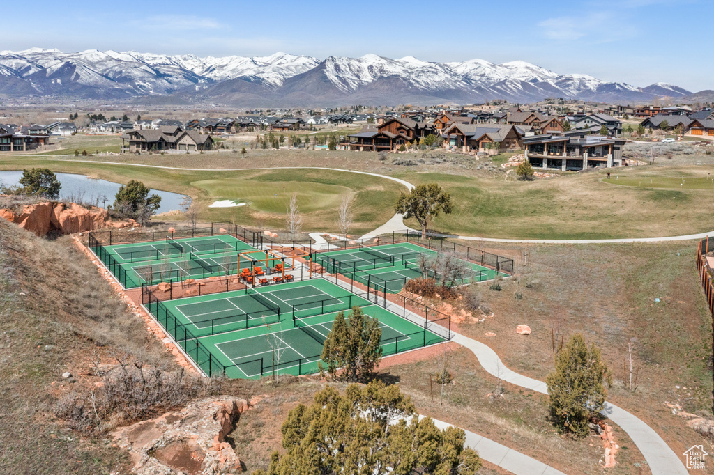 Aerial view of residential area with a water and mountain view and a local golf course