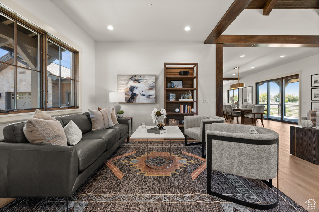 Living room featuring wood finished floors, recessed lighting, and beam ceiling