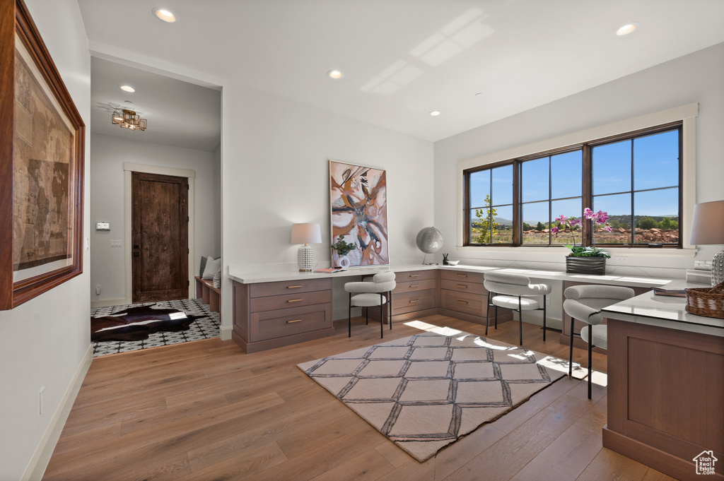 Office space featuring light wood finished floors, recessed lighting, and baseboards