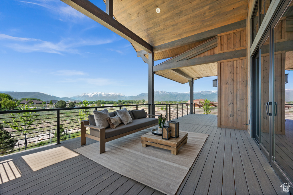 Deck with a mountain view and an outdoor hangout area