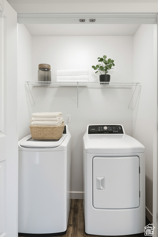 Washroom featuring separate washer and dryer and dark wood-style floors