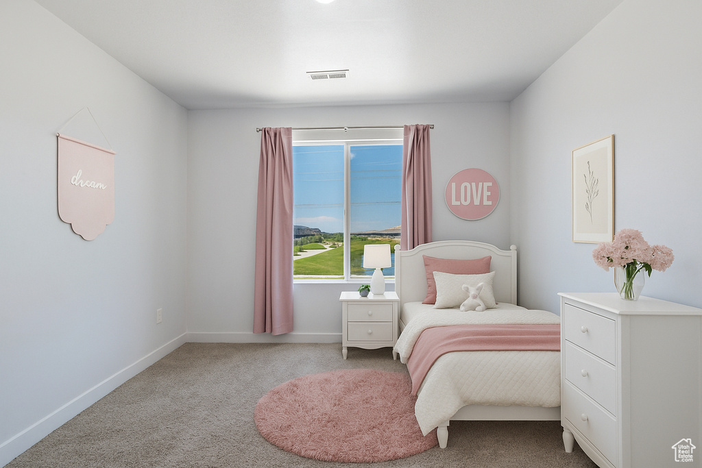 Bedroom featuring carpet and baseboards