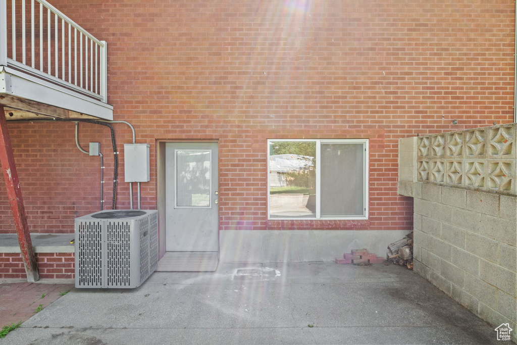 View of patio featuring central air condition unit and a balcony
