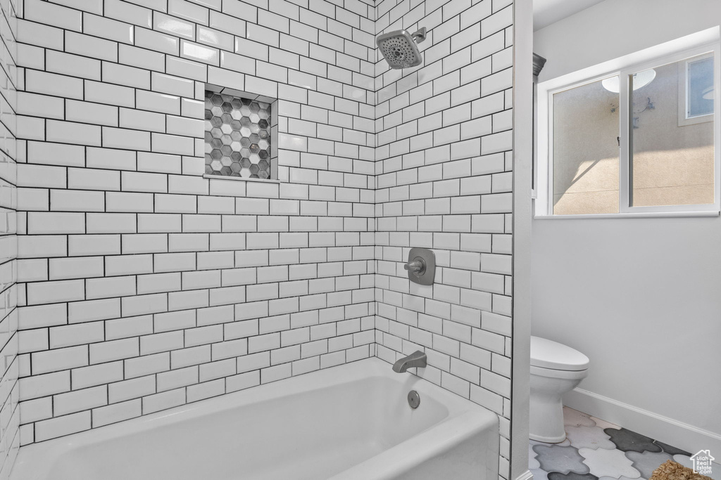 Full bathroom with toilet, baseboards, shower / washtub combination, and marble finish floors