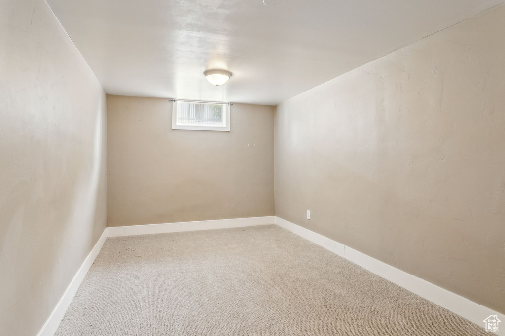 Below grade area with carpet flooring and baseboards