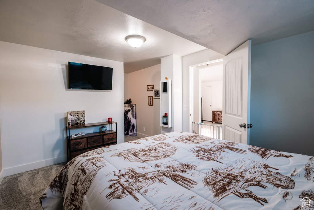 Carpeted bedroom featuring baseboards