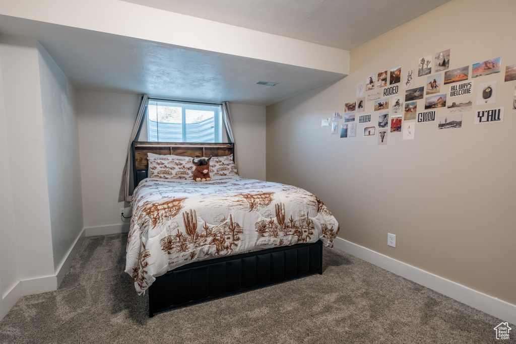 Bedroom with carpet flooring and baseboards