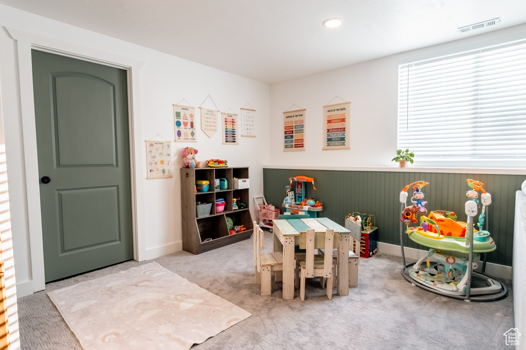 Recreation room featuring a wainscoted wall, carpet floors, and recessed lighting