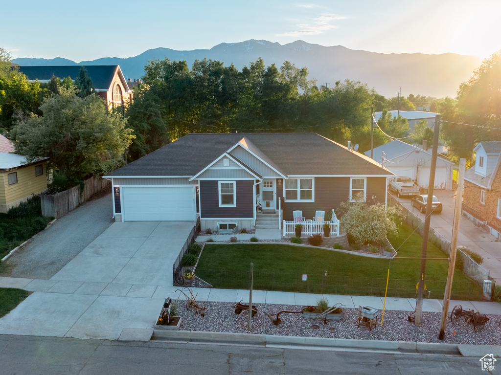 View of front facade featuring concrete driveway, an attached garage, and a mountain view