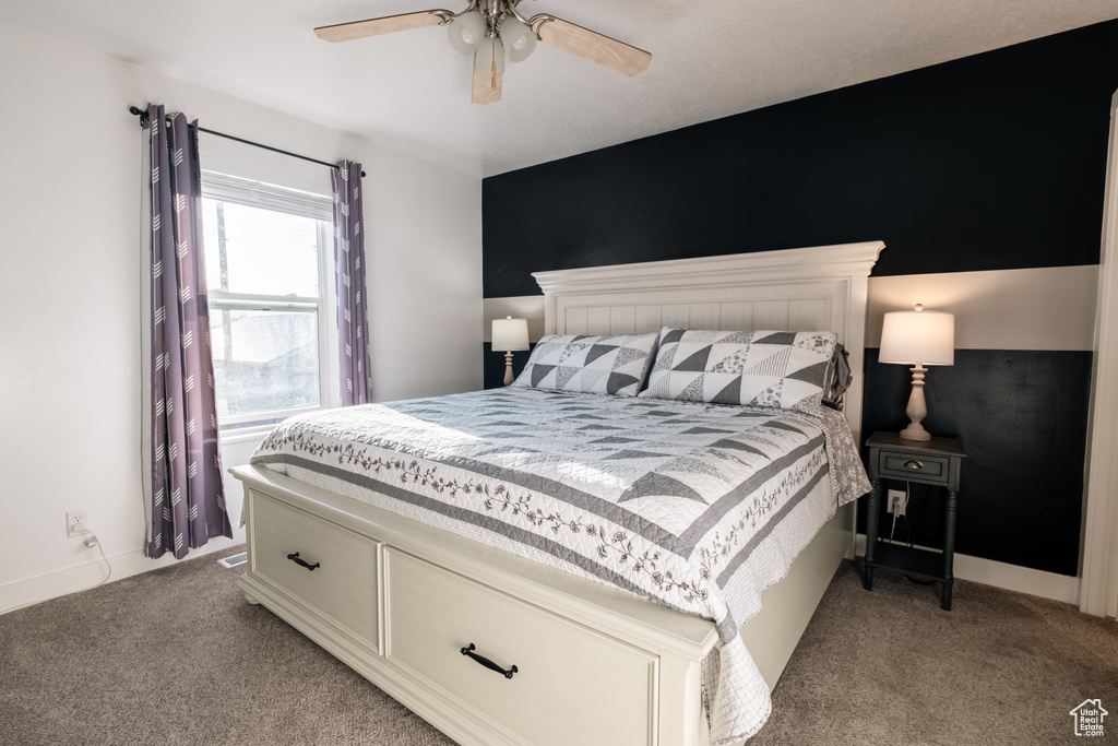 Bedroom featuring light carpet, baseboards, and ceiling fan