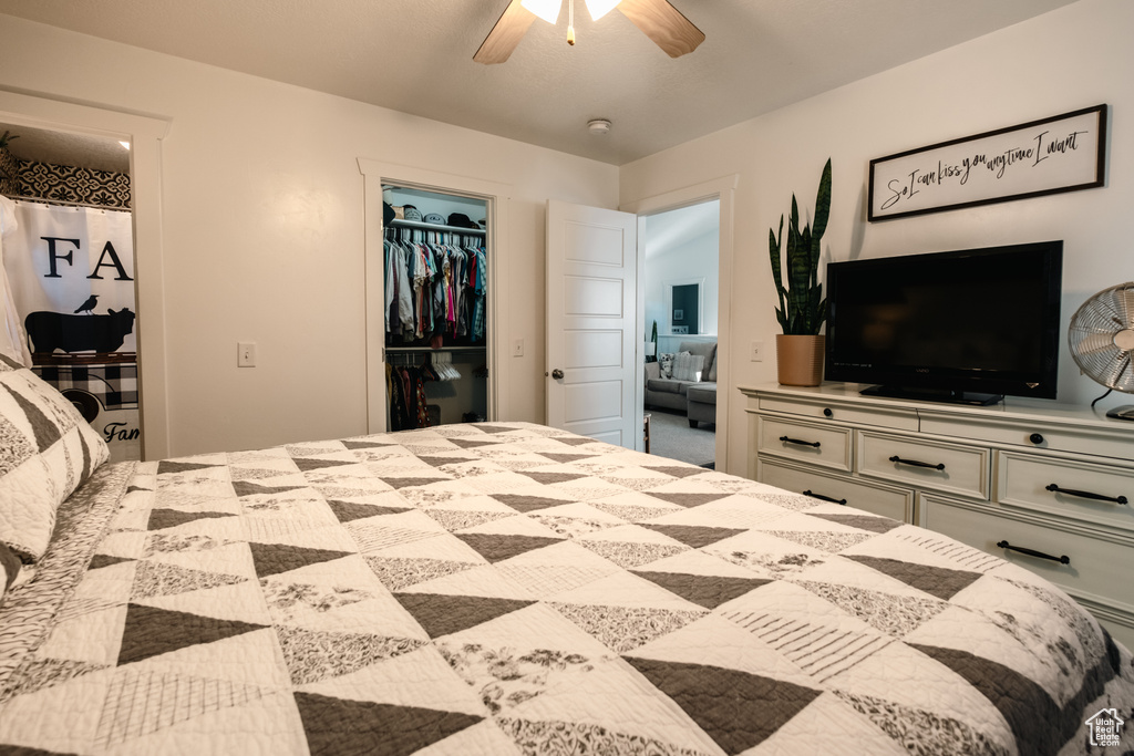 Bedroom with a closet, a walk in closet, and ceiling fan