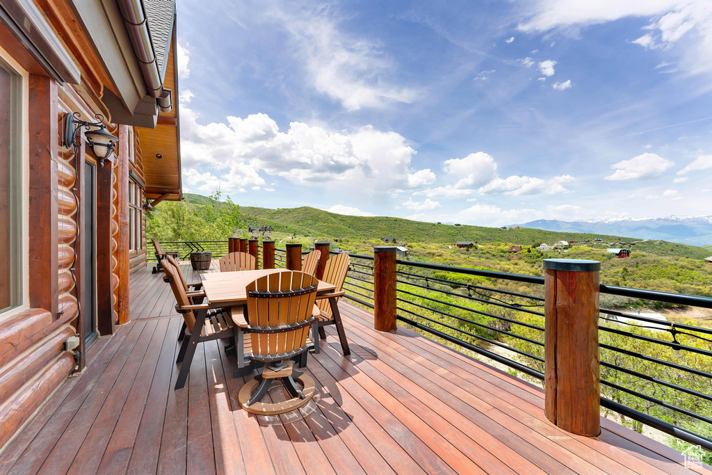 Deck featuring a mountain view and outdoor dining area