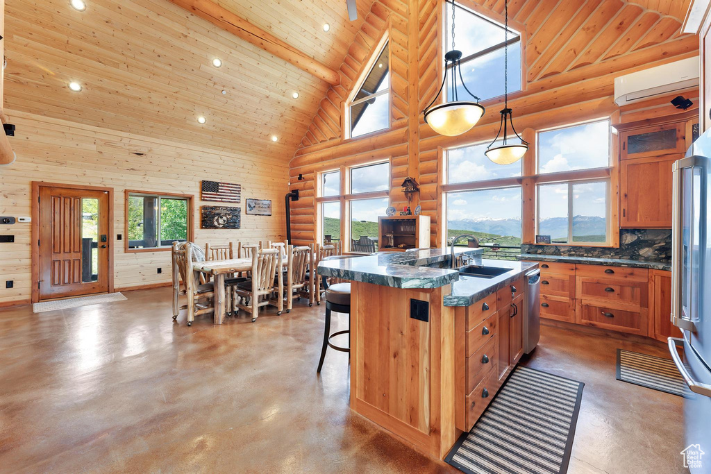 Kitchen featuring high vaulted ceiling, a wall mounted air conditioner, a sink, wooden ceiling, and rustic walls