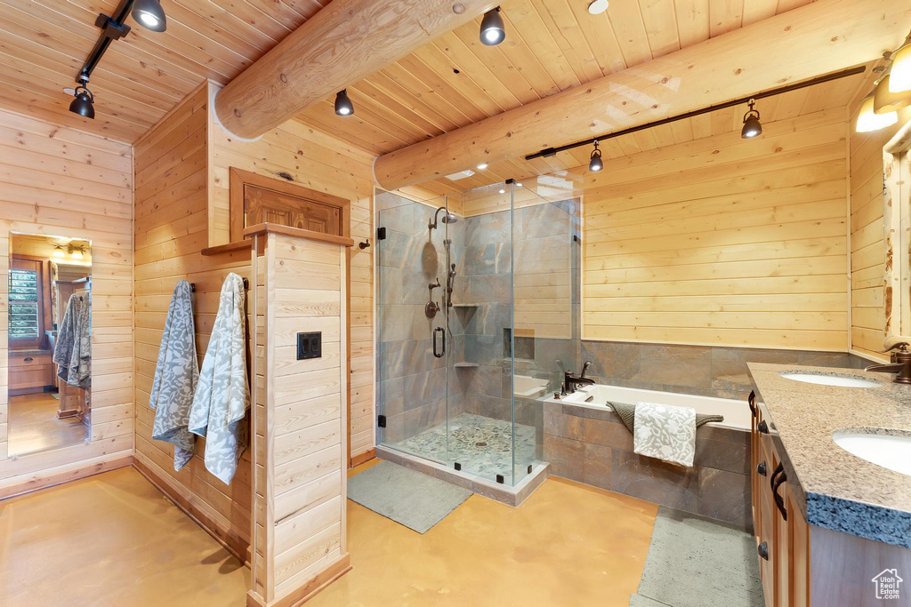 Bathroom featuring track lighting, wood ceiling with exposed beams, wood walls, a garden tub, and a shower stall