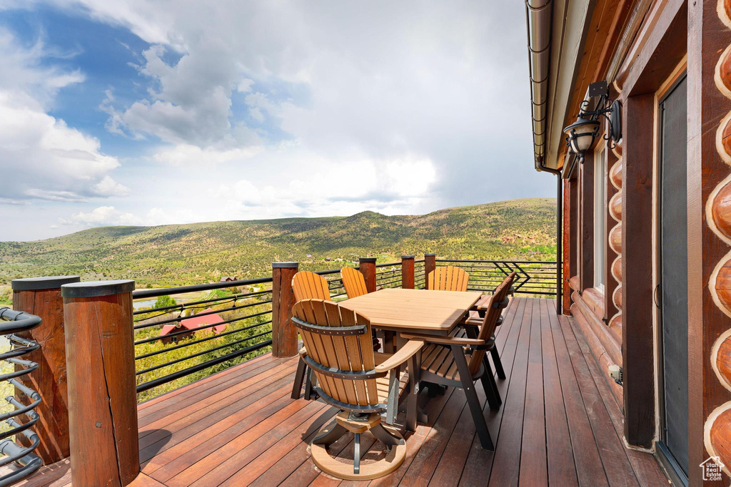 Wooden terrace with a mountain view and outdoor dining space