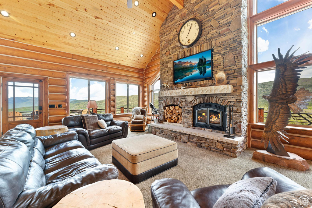 Living room featuring high vaulted ceiling, wood ceiling, carpet floors, rustic walls, and recessed lighting