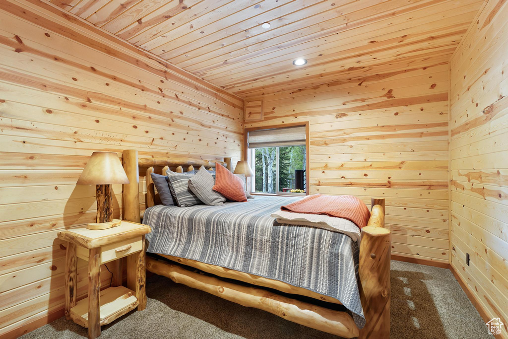 Bedroom with wood ceiling, carpet flooring, wood walls, and recessed lighting