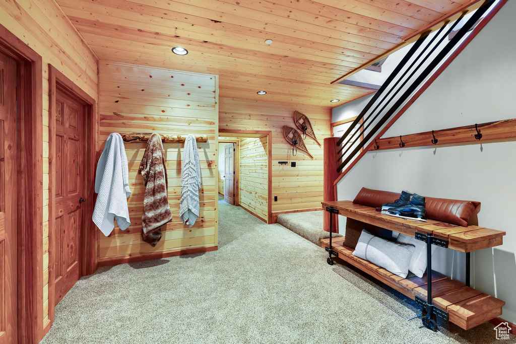 Bedroom with carpet, wood walls, wooden ceiling, recessed lighting, and baseboards