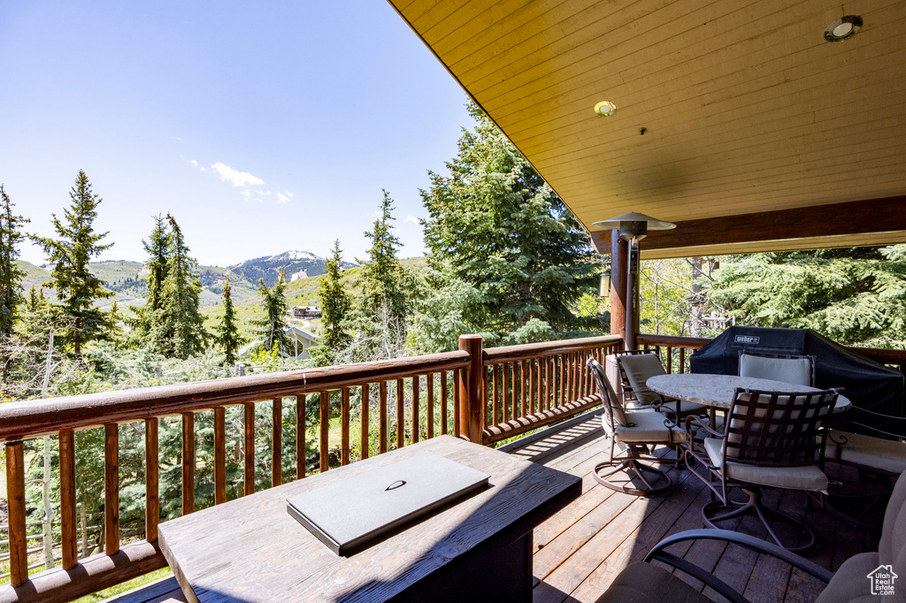 Deck featuring outdoor dining space and a mountain view