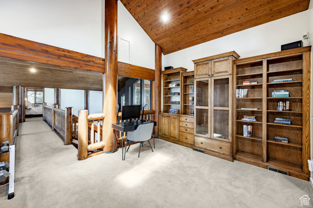 Interior space featuring high vaulted ceiling and wooden ceiling