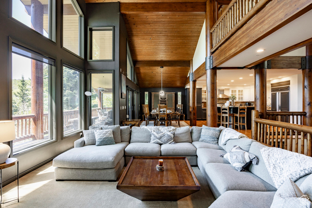 Living area featuring high vaulted ceiling, recessed lighting, and wooden ceiling