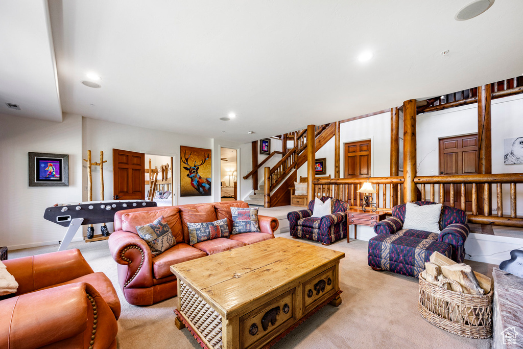 Living room featuring light colored carpet, stairway, and recessed lighting