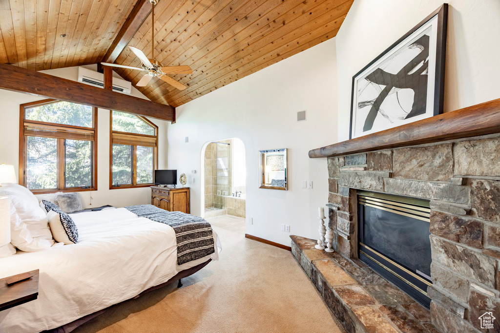 Carpeted bedroom with a fireplace, high vaulted ceiling, wooden ceiling with exposed beams, baseboards, and ensuite bathroom