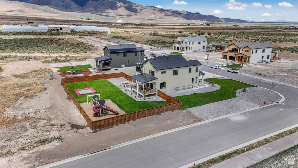 Aerial view of property and surrounding area with mountains