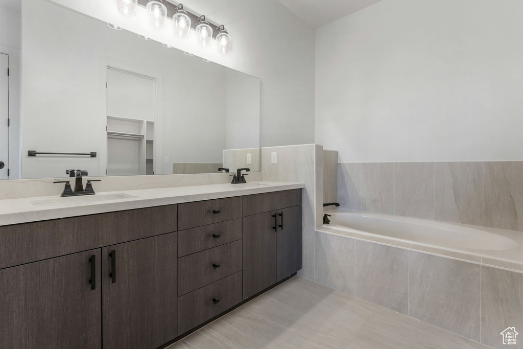 Bathroom featuring double vanity and a garden tub
