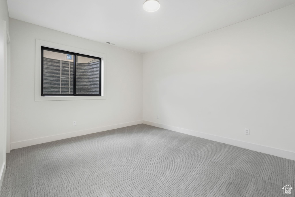 Empty room with baseboards and carpet floors