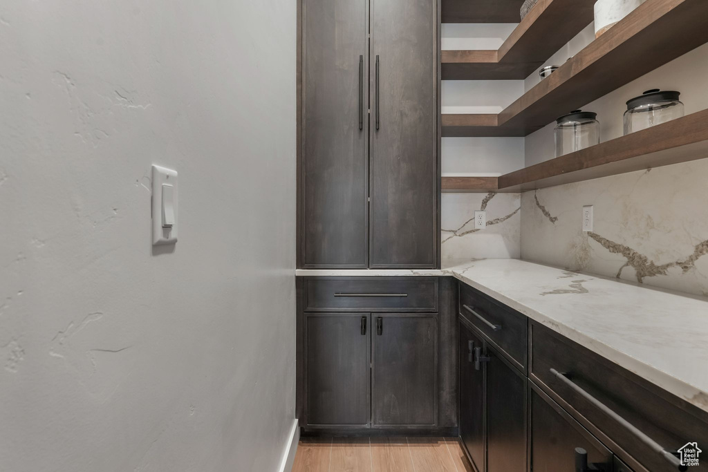 Bar featuring light wood finished floors and baseboards