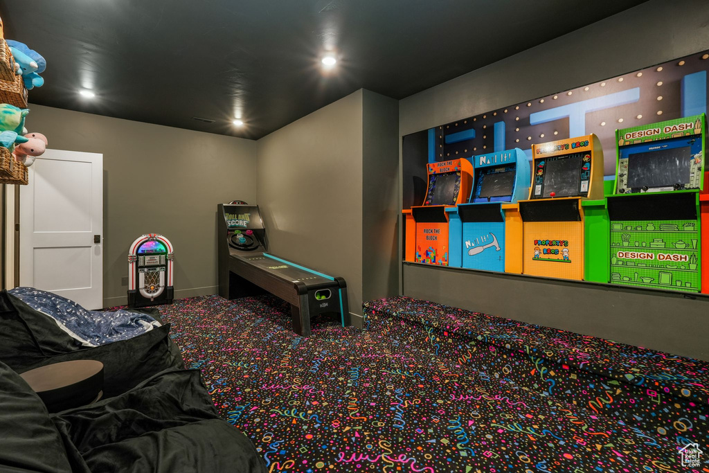 Carpeted home theater with baseboards