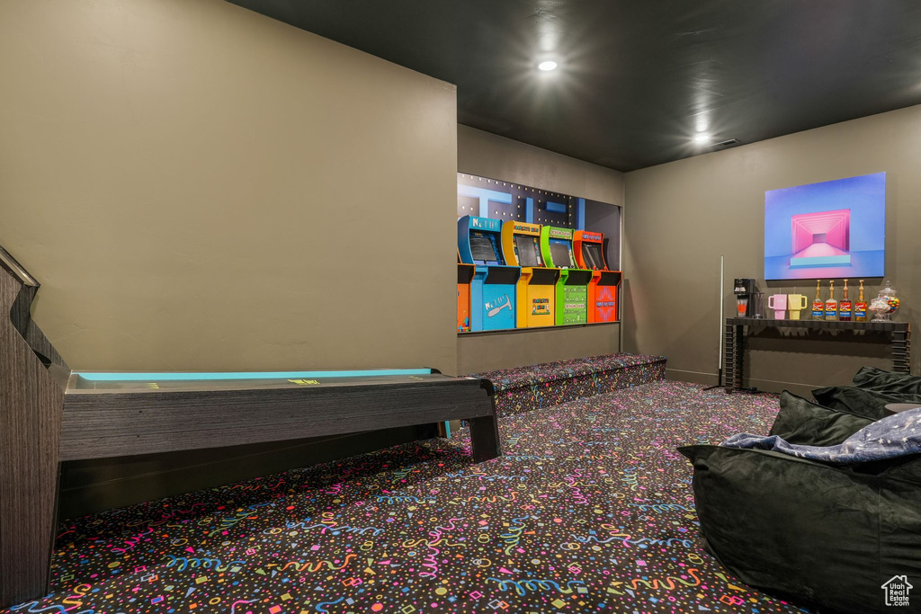 Rec room with carpet and baseboards