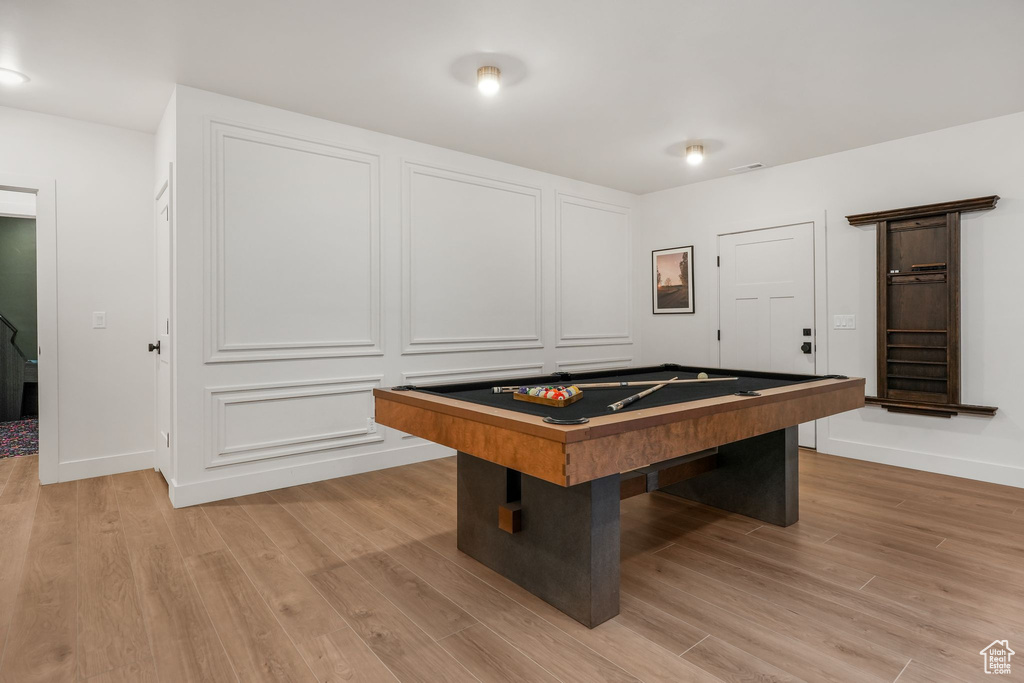 Rec room with light wood-style flooring, pool table, and baseboards