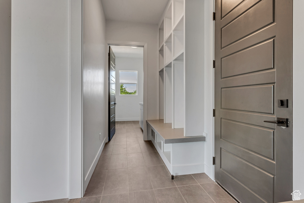 Mudroom featuring tile patterned flooring and baseboards