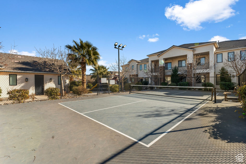 View of tennis court featuring a residential view